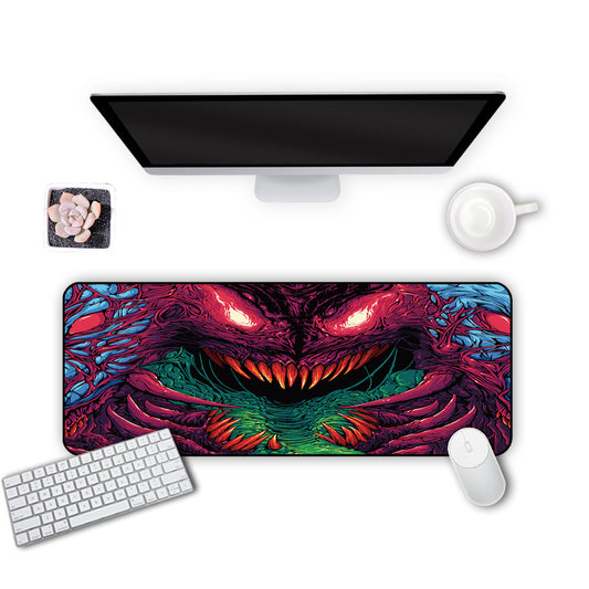 Desk setup with a large dragon-themed mouse pad, keyboard, mouse, and monitor on a white background.