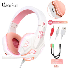 Pink and white gaming headset with volume control, cables, and adapter on a white background.
