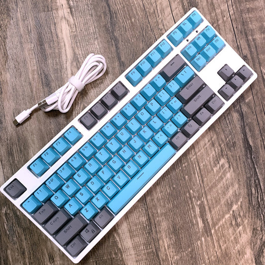 Mechanical keyboard with blue keys and gray accents on a wooden surface