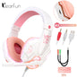 Pink and white gaming headset with volume control, cables, and adapter on a white background.