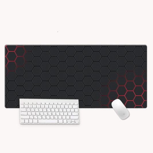 Black hexagonal patterned mouse pad with a white keyboard and mouse on a white background
