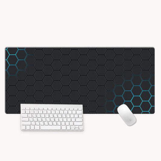 Black honeycomb patterned mouse pad with a white keyboard and mouse on a white background